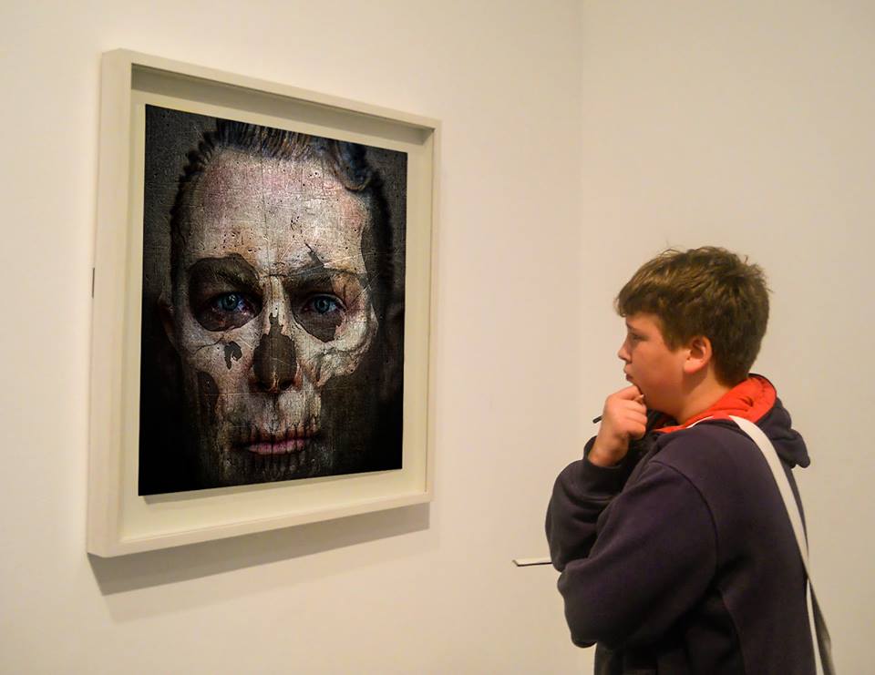 Looking at an art work by TD . Berlin